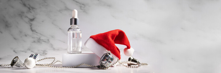 Facial serum on Christmas banner, a cosmetic bottle on a beauty podium with a gift box and Santa's...