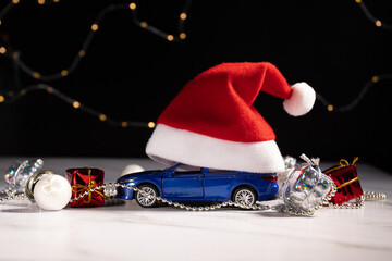 Car gift in Santa hat on Christmas background, a surprise vehicle wrapped for the holiday. The perfect festive backdrop for a merry and happy season, ideal for a new year celebration