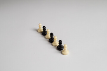 black and white chess pieces in one line, on white background, racism concept