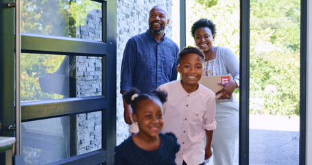 Moving, black family in new home with children, boxes and smile at front door with property...