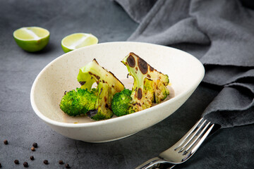 baked broccoli in mushroom sauce on a white plate side view