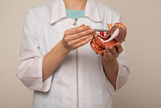 woman doctor pointing at stomach mockup