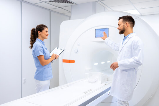Doctors preparing MRI scanning machine for use in hospital.