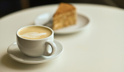 delicious cake on the table with a latte coffee cup