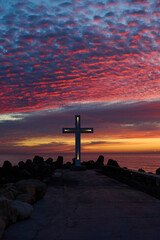 Christian Holy cross early in the morning at sunrise. The large cross stands on the edge of a...