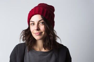 Portrait of a tender woman in her 30s sporting a trendy beanie against a white background. AI Generation