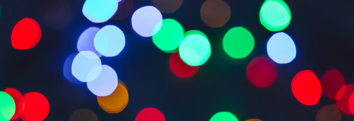 Banner. Colourful festive bokeh lights on background. Abstract multicolored light. Christmas or New...
