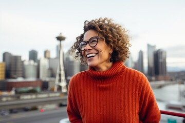 Portrait of a joyful woman in her 50s wearing a cozy sweater against a vibrant city skyline. AI Generation