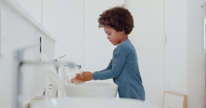 Child, washing hands and water with soap in bathroom with sanitary, hygiene and grooming routine in sink. Cleaning, skin and kid learning self care in home with disinfection of bacteria and germs