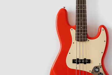 Red bass guitar on white background. Music wallpaper