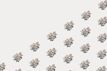 Silver ribbon bows isolated on white background. Minimal holiday gift concept. Greeting card idea. Copy space.