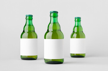 Green steinie beer bottle mockup with blank label.