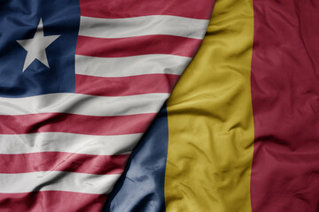 Obraz premium big waving national colorful flag of chad and national flag of liberia .