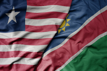 big waving national colorful flag of namibia and national flag of liberia .