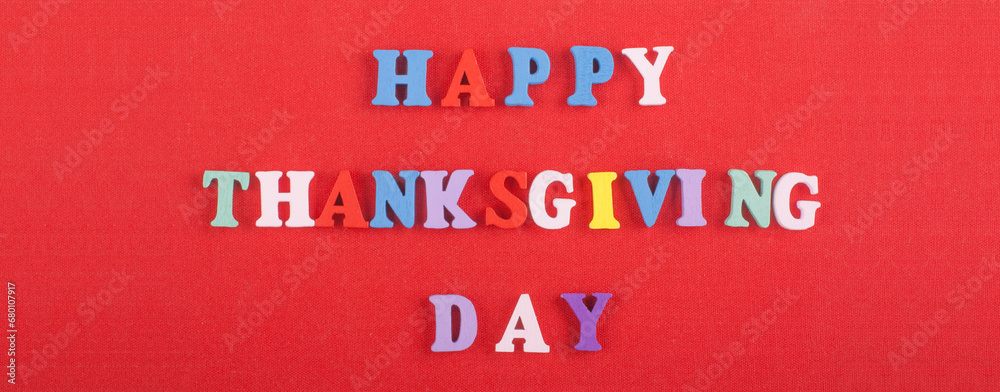 Fototapete happy thanksgiving day word on red background composed from colorful abc alphabet block wooden lette