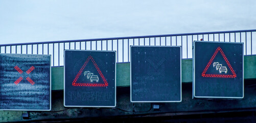 Automated sign bridge over a Berlin motorway with temporary traffic jam warnings.