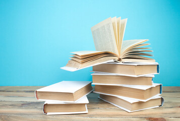open book, books on the blue background. Back to school. Education. Copy space for text.