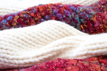 Knitted woolen sweaters. A bunch of knitted winter, autumn clothes, sweaters, knitwear, space for the text.