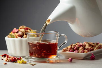 Herbal tea is poured into a mug.