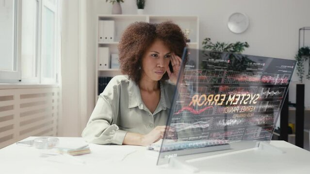 Female IT specialist encounters system error while working with futuristic tech