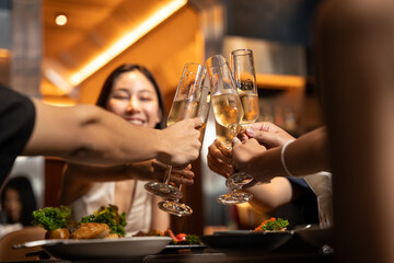 Group of People Holding Beer and Cheer in Restaurant. They Enjoying with Night Party Together. Party, Lifestyle, Happiness, Cheerful and Celebration concept. 