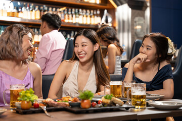 Beautiful Asian Woman Enjoying with Friend in Bar. They Drinking Cocktail Together in Bar Counter. Party, Lifestyle, Happiness, Cheerful and Celebration Concept.