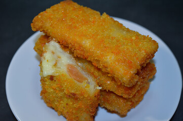 Risoles Mayonnaise or Risol Mayo, Indonesian street food made from flour shell filled with mayonnaise and sausage. selective focus.