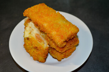 Risoles Mayonnaise or Risol Mayo, Indonesian street food made from flour shell filled with mayonnaise and sausage. selective focus.