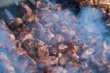 Obraz na płótnie Canvas Pork meat is fried on smoking coals in the grill