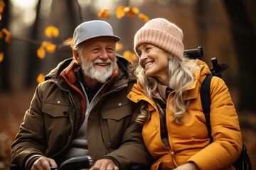 Fototapeta premium a couple of disabled people in an autumn park on a wheelchair
