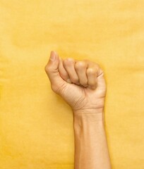 fist punching through paper, Male left hand counting one isolated.