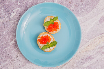 White crispy French baguette bread and red caviar