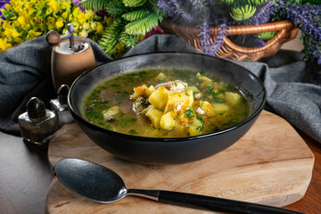 Cucumber soup in dark bowl.