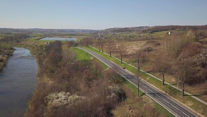 Panorama of road from a bird's eye view. Central Europe:  town or village is located among the green hills. Temperate climate. Flight drones or quadrocopter.