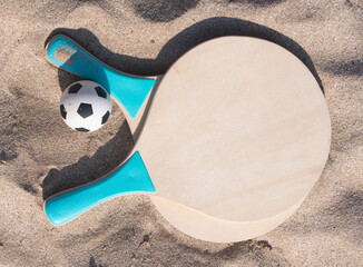 Beach ball rackets and a ball on a beach sand - 680133586