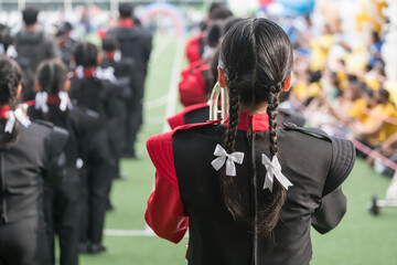 Rear female student in school marching band in school sport day