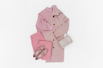 Classic pale pink trench coat with jeans and loafers. Fashion spring or autumn outfit. Women's stylish and elegant clothes with accessory.  Flat lay, top view, overhead.