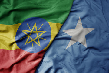 big waving national colorful flag of somalia and national flag of ethiopia . - obrazy, fototapety, plakaty