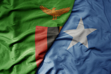 big waving national colorful flag of somalia and national flag of zambia .