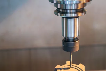 Fotobehang The CNC milling machine cutting the graphite electrode parts. © Pixel_B