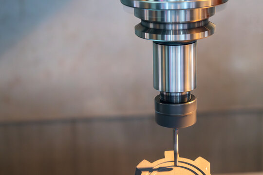 The CNC milling machine cutting the graphite electrode parts.
