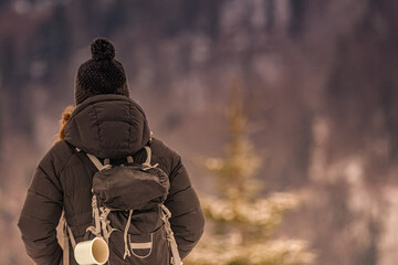 Young woman hiking in snowy mountains. Young woman hiking outdoors.