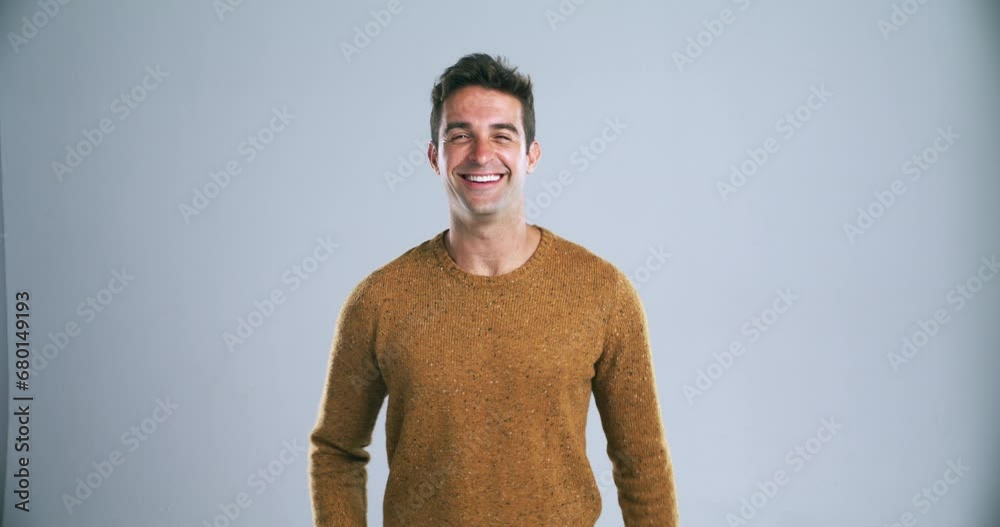 Poster young happy man, pointing and calling you in confidence isolated against a gray studio background. p