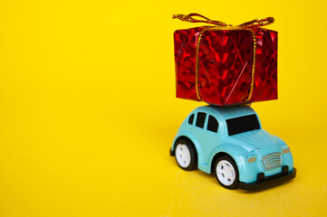 Toy car carrying present in red with customizable space for text
