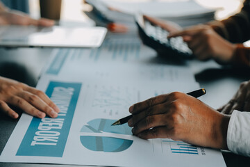 Financial analysts analyze business financial reports on a digital tablet planning investment project during a discussion at a meeting of corporate showing the results of their successful teamwork.