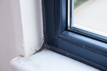 Closeup of wall crack near window frame. Home repair concept