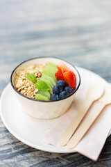 Healthy food rich vitamin and fiber morning meal bowl. colorful mix berry fruity with cereal whole grain food vertical shot.
