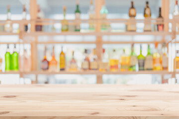 blur cocktail pub restaurant wooden counter bar with alcohol bottles drink mixer full on shelf background for advertising montage.