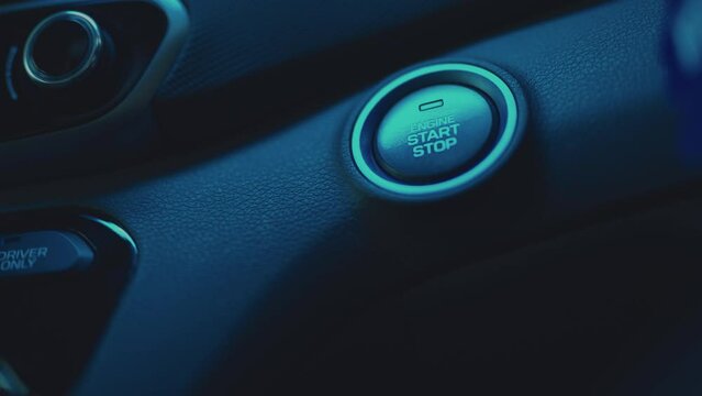 Pressing ignition start button in car, close up
