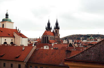 Obraz premium Amazing scenic view of rooftops and Church of Our Lady before Tyn in Prague, Czech Republic - autumn season. The historic center of the city Prague - view from the window of flat.